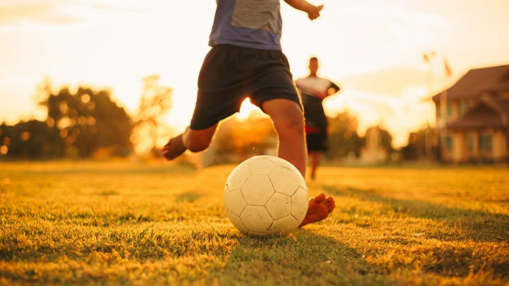 action sport outdoors of kids having fun playing soccer football for exercise